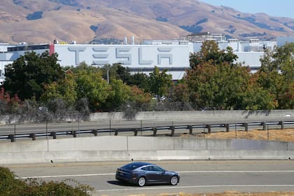FILE — A Tesla car passing the company’s factory in Fremont, Calif. on Oct. 2, 2023. Tesla dominates the electric car market with about half of all sales in the most recent quarter. (Jim Wilson/The New York Times)