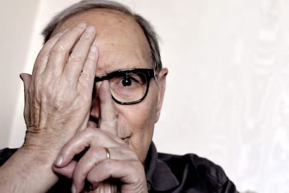 (FILES) In this file photo taken on July 03, 2017 Italian composer Ennio Morricone poses during an interview in Rome. - Ennio Morricone, one of the world's best-known and most prolific film composers, has died in Rome, Italian media reported on July 6, 2020. (Photo by TIZIANA FABI / AFP)