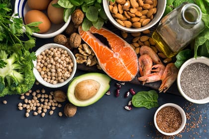 Food sources of omega 3 and healthy fats on dark background top view. Copy Space. Vegetables, seafood, nut and seed