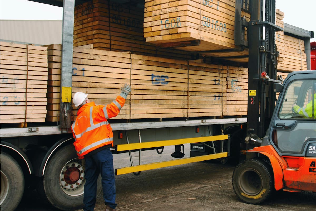 Forklift lifting timber onto an articulated lorry on the dockside at a port in Newport, South Wales, UK. (Photo by Adrian Sherratt/Construction Photography/Avalon/Getty Images)
