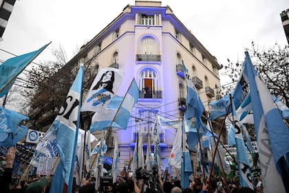 Former Argentine president (2007–2015) Cristina Kirchner appears in the balcony of her home as she remains under house arrest in Buenos Aires on June 10, 2026. Kirchner marks her first year since being sentenced to six years in house arrest and banned from holding public office for life. (Photo by Luis ROBAYO / AFP)