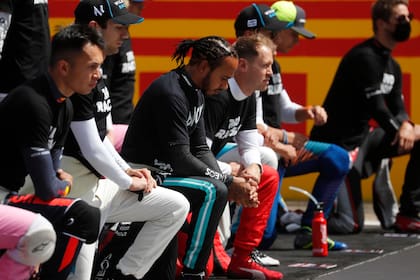 Formula One F1 - British Grand Prix - Silverstone Circuit, Silverstone, Britain - August 2, 2020 Mercedes Lewis Hamilton and drivers kneel on the grid before the race in support of the Black Lives Matte
