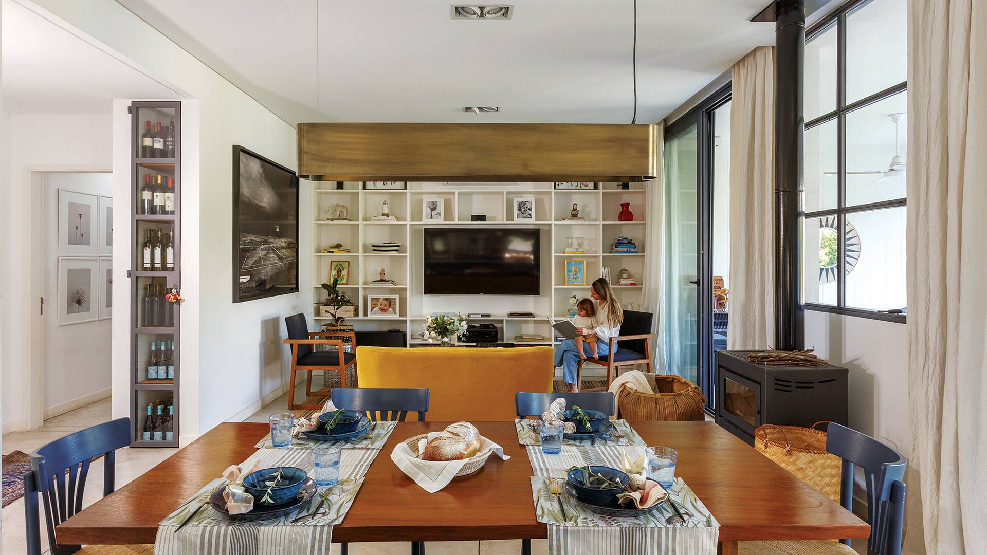 Foto de un comedor integrado al living con mesa de timbó, caminos, individuales y servilletas.