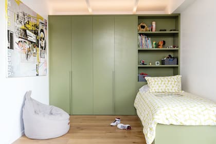 El placard empotrado se transforma en estantería para el guardado de libros y juguetes. Fue pintado en verde ‘Edamame’ (Sherwin Williams), al igual que la cama, y así unifica el criterio.
Cubrecama a medida (Cuqui Najo).