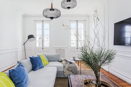 Lámparas (Frida Casa), mesa de centro (Paul French Gallery), alfombra de yute (Girona Home). Sillón diseñado a medida con funda de tussor color gris hielo (Bakana Interiorismo).