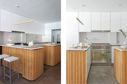 Alacenas laqueadas en blanco hechas a medida. Mesada y alzada de Silestone. Campana (TST). Cocina industrial (Morelli). Heladera (LG). Banquetas y frutera (Diseño Base).