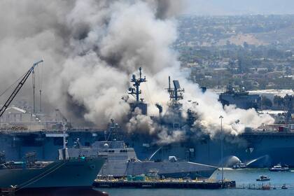 Fotografía de archivo del 12 de julio de 2020 de humo saliendo del buque militar Bonhomme Richard en la Base Naval de San Diego, luego de una explosión e incendio a bordo del barco. (AP Foto/Denis Poroy, Archivo)