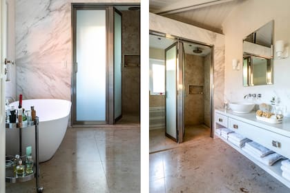 La apariencia monocromática de este baño en suite se diluye al contacto con las texturas del mármol y los matices de la luz.