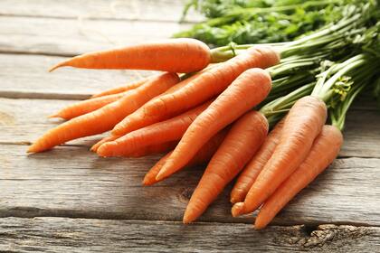 Fresh and sweet carrot on a grey wooden table