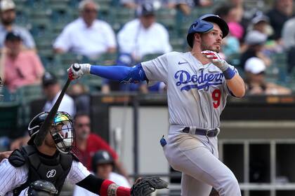 Gavin Lux, de los Dodgers de Los Ángeles, dispara un doble productor contra los Medias Blancas de Chicago, en el noveno inning del partido en Chicago, el jueves 9 de junio de 2022. (AP Foto/Charles Rex Arbogast)