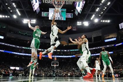 Giannis Antetokounmpo, de los Bucks de Milwaukee, deja atrás a Daniel Theis, de los Celtics de Boston, para anotar en la segunda mitad del partido del jueves 7 de abril de 2022, en Milwaukee, Wisconsin. (AP Foto/Morry Gash)