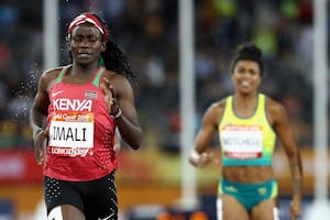 GOLD COAST, AUSTRALIA - APRIL 10: Maximila Imali of Kenya, Morgan Mitchell of Australia and Anyika Onuora of England compete in the rain during the Women's 400 metres semi finals during the Athletics on day six of the Gold Coast 2018 Commonwealth Games at Carrara Stadium on April 10, 2018 on the Gold Coast, Australia. (Photo by Cameron Spencer/Getty Images)