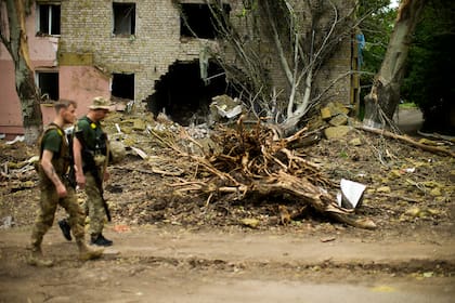 Los escombros cuelgan de un edificio residencial gravemente dañado por un bombardeo ruso en Bakhmut, en el este de Ucrania, el sábado 28 de mayo de 2022. (AP Photo/Francisco Seco)