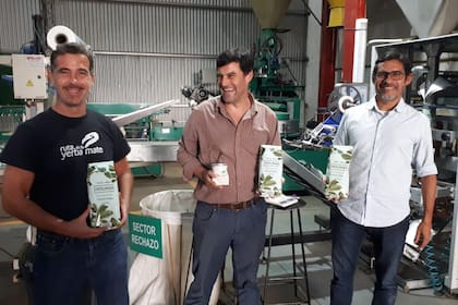 Héctor Dingler (centro), titular de la Cooperativa 2 de Mayo con paquetes de la marca Indumar, que lanzó hace pocos años esta asociación de 123 productores; a la izquierda, Alejandro Gruber, un promotor de la yerba mate y creador de la Asociación Ruta de la Yerba Mate (ARYM)
