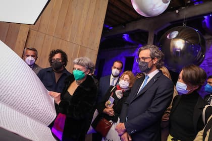 Heller muestra la novela gráfica que acompaña el envío, en una recorrida con las autoridades presentes