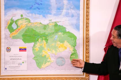 Hermann Escarra, presidente de una comisión venezolana sobre la disputa territorial con Guyana, junto a un mapa en que el Esequibo está integrado al territorio venezolano, en Caracas, Venezuela, el 8 de diciembre del 2023.