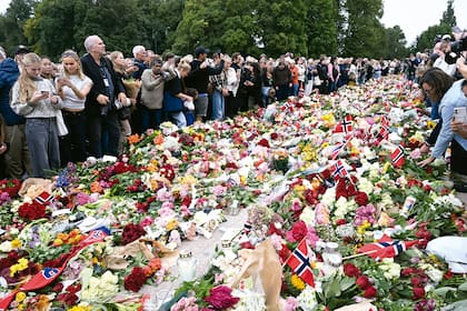 Un mar de flores, cartas y banderas en las inmediaciones del Palacio Real