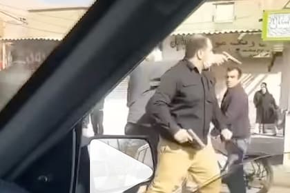 Hombres armados vestidos de civil en Kermanshah, Irán.