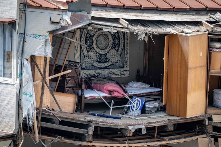 Household items are seen in a damaged house in Yatsushiro, Kumamoto prefecture on July 29, 2026, after an earthquake struck southwestern Japan the previous day. (Photo by Yuichi YAMAZAKI / AFP)