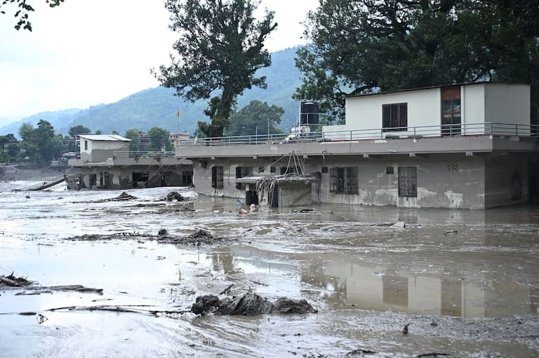 Houses lie deluged in sludge after flash floods at Devghat in Nepal's Nuwakot district on August 26, 2026. Massive flooding killed eight people in Nepal on August 26, as Chinese state media reported "major casualties" from a mudslide at a Tibet trade hub on China's side of the nations' shared border. (Photo by Prakash MATHEMA / AFP)