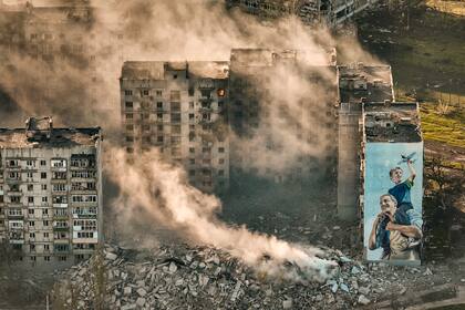 Humo cubre edificios en Bajmut, el lugar en donde se desarrollaron los combates más intensos contra soldados rusos en la región Donetsk, Ucrania, el miércoles 26 de abril de 2023. (AP Foto/Libkos)