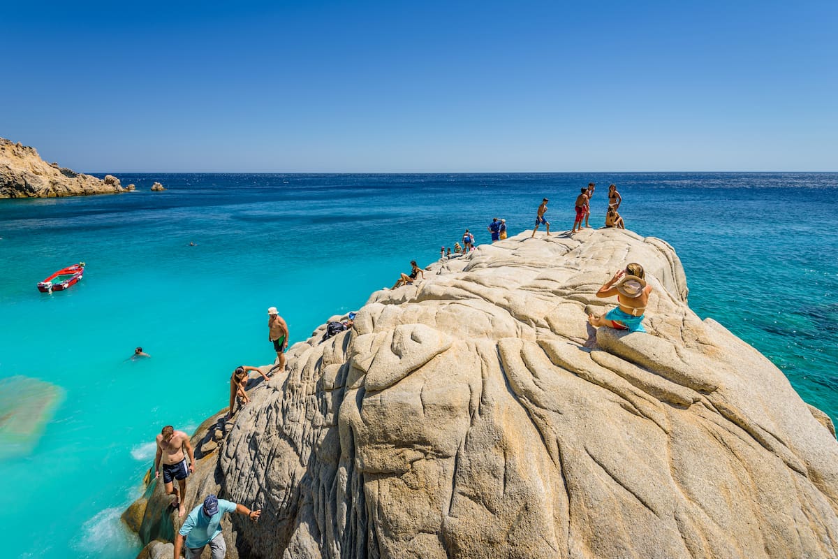 Ikaria Island, Seychelles Beach, Sporades/ Greece - 08 01 2017: Beautiful sunny coast view to a amazing paradise holiday bay with crystal clear blue water sandy beach for sunbathing swimming relaxing
