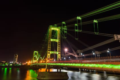 Illuminated suspension bridge, Santa Fe, Argentina.