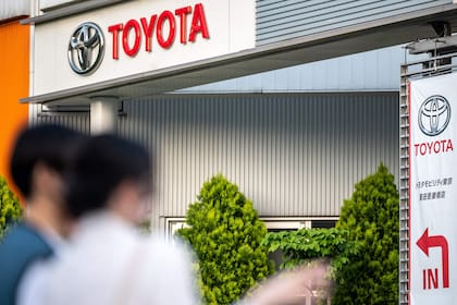 In this picture taken on May 10, 2022, a sign for Japan's Toyota Motor is displayed at a dealership in Tokyo. (Photo by Philip FONG / AFP)