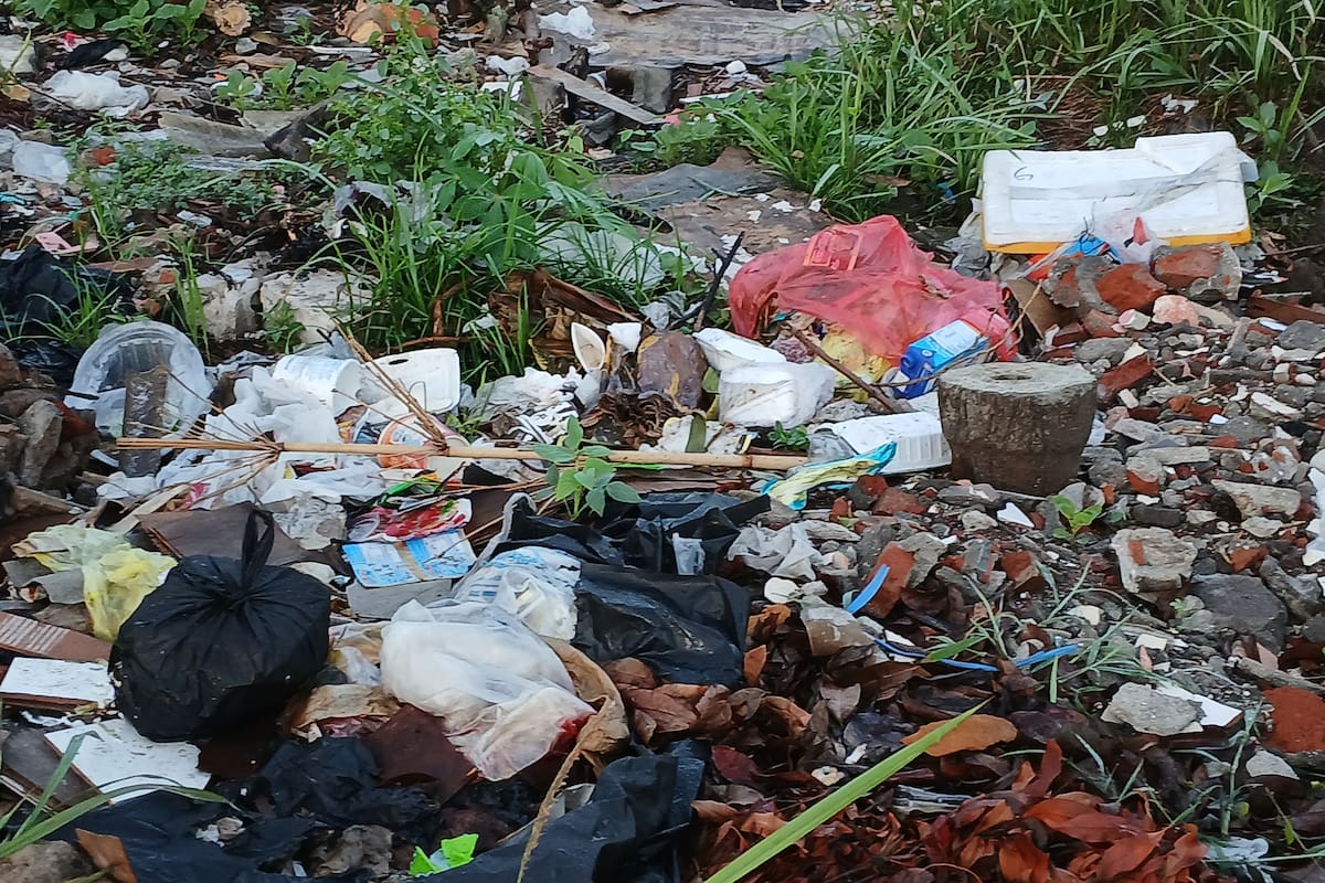 Indonesia, 22 October 2024 : A pile of plastic trash is scattered across the ground. Bottles, bags, and food wrappers litter the landscape, creating a visually unpleasant scene. The image serves as a