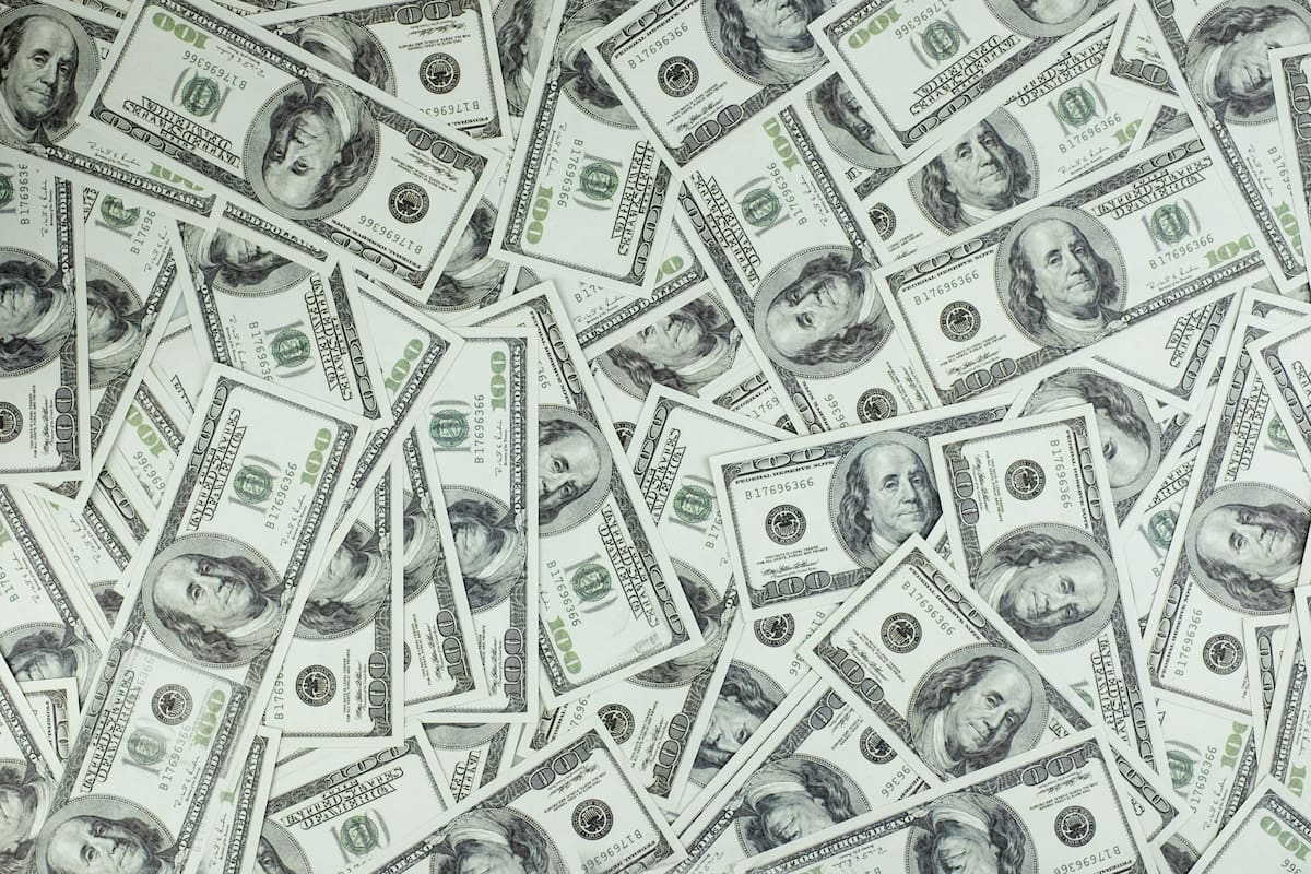 It is a collection of money stacks of 100 US dollar banknotes that make up a large portion of the background, top view