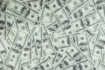 It is a collection of money stacks of 100 US dollar banknotes that make up a large portion of the background, top view