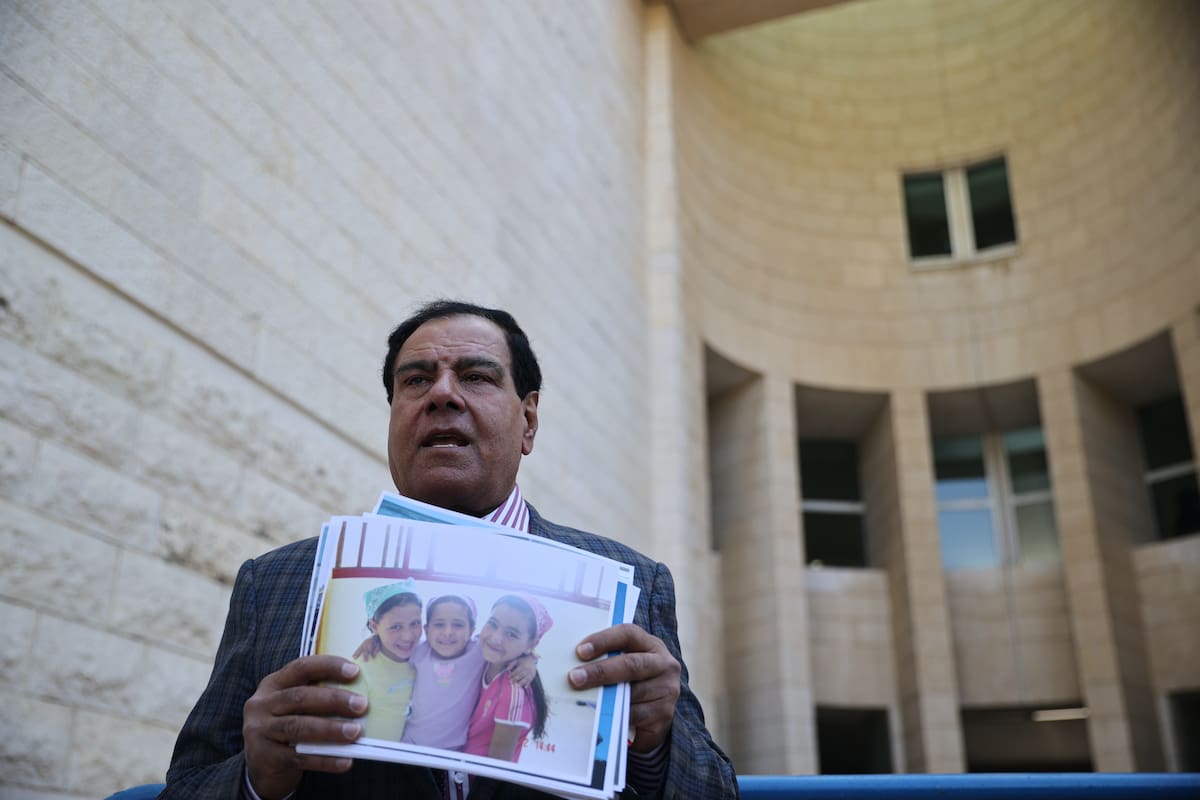 JERUSALEM - NOVEMBER 15: Palestinian doctor Izzeldin Abuelaish speaks to media holding the photos of his daughters, at hearing room on November 15, 2021 in Jerusalem. The hearing of the case brought against the Tel Aviv administration by Palestinian doctor Izzeldin Abuelaish, who lost three of his daughters during the Israeli attacks on the Gaza Strip in 2009, was held at the Israeli Supreme Court in Jerusalem. (Photo by Mostafa Alkharouf/Anadolu Agency via Getty Images)