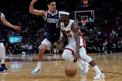 Jimmy Butler, alero del Heat de Miami, dribla a Josh Green, de los Mavericks de Dallas, en el encuentro del sábado 1 de abril de 2023 en la Arena del Heat de Miami. (AP Foto/Marta Lavandier)