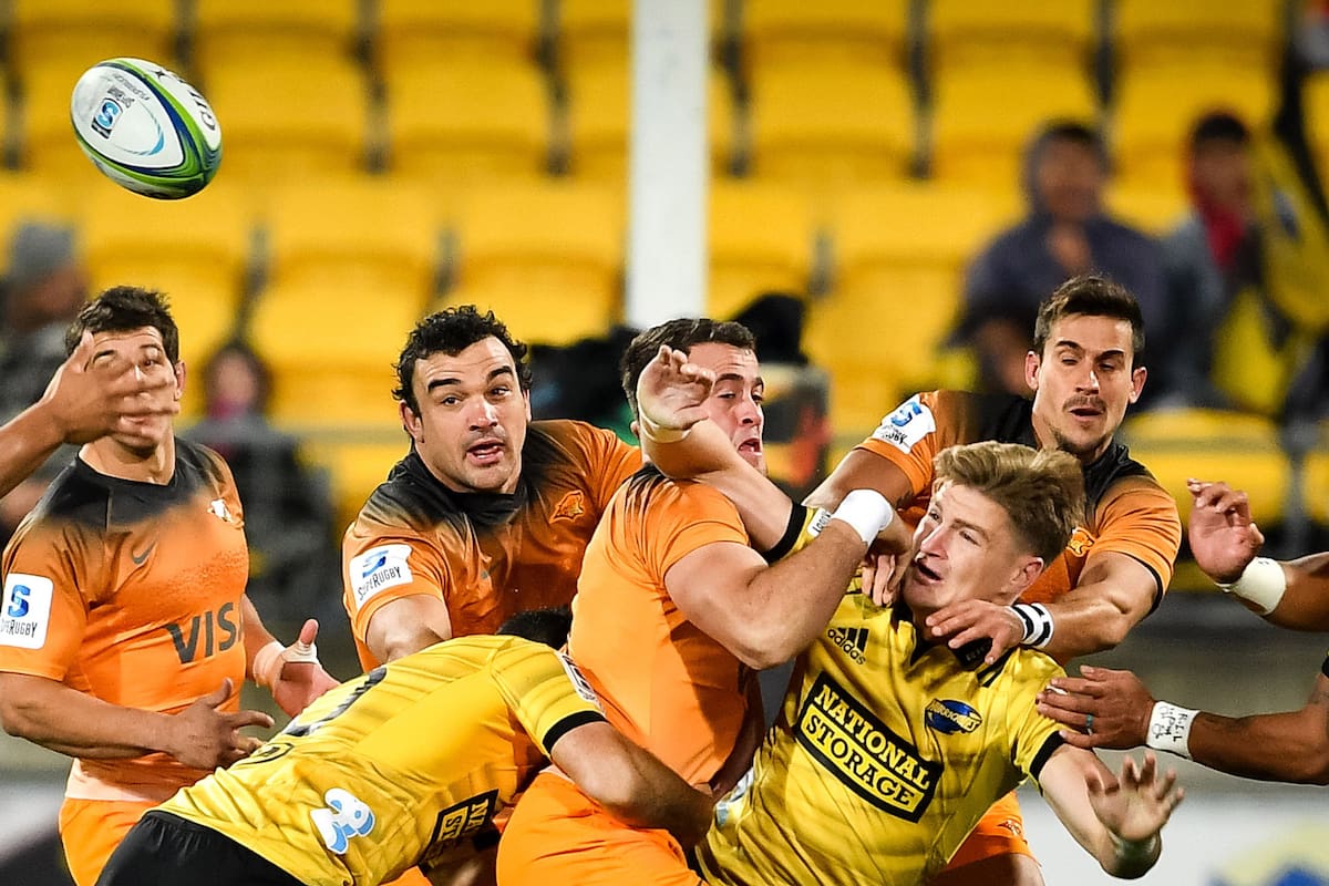 Jordie Barrett (2nd R) of the Hurricanes clears while Emiliano Boffelli (R) of the Jaguares tackles him during the Super Rugby match between Argentinas Jaguares and New Zealands Hurricanes at Westpac Stadium in Wellington on May 17, 2019. (Photo by MARK TANTRUM / AFP)
