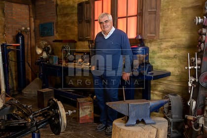 Juan Carlos posa en “El viejo taller”, en el segundo nivel del museo, que recrea el taller de Fangio.