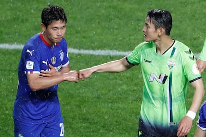Choque de puños para saludarse en el inicio la K-League, de Corea del Sur.