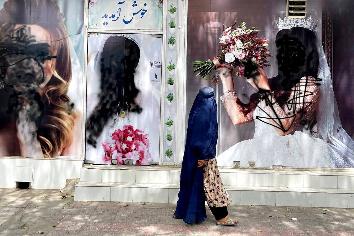 KABUL, AFGHANISTAN - AUGUST 20: Women posters on beauty salon windows remain vandalized in Kabul, Afghanistan on August 20, 2021. (Photo by Haroon Sabawoon/Anadolu Agency via Getty Images)