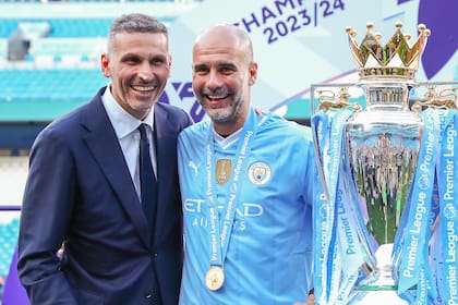 Khaldoon Al Mubarak, presidente del Manchester City, junto a Pep Guardiola y uno de los trofeos de la Premier League obtenidos