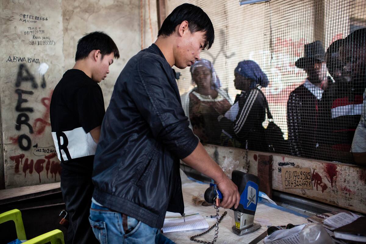 KOLWEZI, DRC: Xu Bin Liu (30) from Hebei in China tests the purity of cobalt he's buying at the Musompo market on the outskirts of Kolwezi. "n"n"nCobalt is a vital mineral needed for the production of rechargeable batteries. Two thirds of the world supply is located in southern Congo where men, women and children all work. Efforts are being made to stop child labor in the cobalt mines, but they have not been successful."n"nBatteries needed for phones, computers and electric cars have pushed the global demand for Cobalt through the roof. Chinese companies and middlemen have the strongest hold on the market. Tech companies like Apple, Microsoft and Tesla are trying to find a way to access Congolese cobalt in a more humane way with proper accountability.