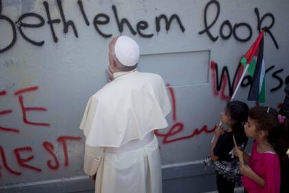 l papa Francisco ora junto a un muro erigido por Israel en su camino a una misa en Belén, en 2014