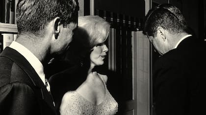 La actriz junto a los hermanos John F. y Robert Kennedy, en la velada en que se celebró el cumpleaños número 45 del presidente estadounidense