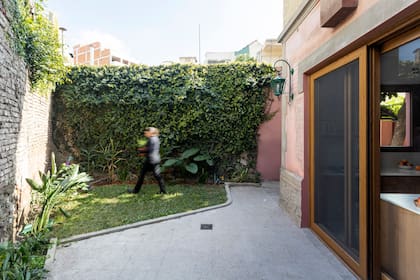La conexión entre la cocina y el patio, antes dada por una pequeña puerta, ahora es mucho más potente. Eligieron aberturas de PVC símil madera para seguir la línea de las ventanas originales.