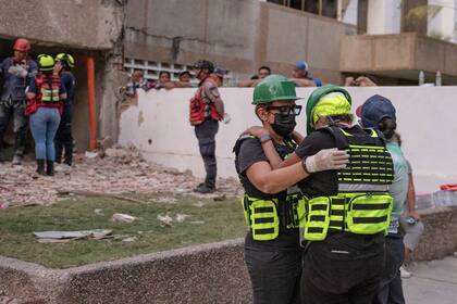 La Dra. Zaira Medina, directora del Hospital Pérez de León de Caracas, abraza a otros posibles rescatistas en La Guaira, Venezuela, dos días después de los terremotos