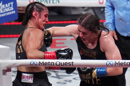 La irlandesa Katie Taylor asesta un golpe a la boricua Amanda Serrano en su combate del viernes 15 de noviembre de 2024 en Arlington, Texas (AP Foto/Julio Cortez)