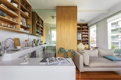 La mesa de 75cm de alto con tapa de Neolith y la mesada de 90cm de Silestone ‘White Storm’ (Marmolería San Marco) se encuentran y prolongan así las superficies de apoyo. Bacha ‘q40’ (Johnson). Grifería (FV).