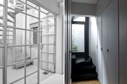 La nueva escalera, con escalones de madera negra y baranda de vidrio (MTD Arquitectura).