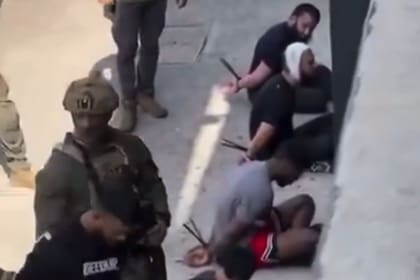 La policía detuvo a los sospechosos y los esposó