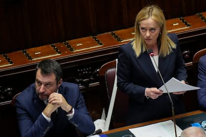 La primera ministra italiana, Giorgia Meloni, de pie junto al ministro de Infraestructura, Matteo Salvini, en el Parlamento de Italia, en Roma el 23 de octubre de 2022. (Foto AP/Alessandra Tarantino)