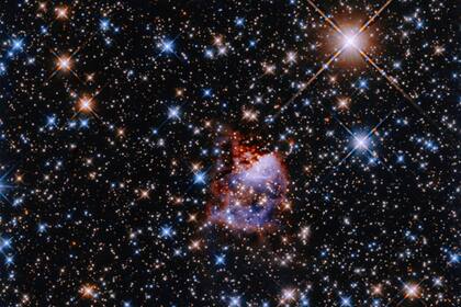 La región de formación estelar G033.91+0.11 alberga una protoestrella oculta dentro de una nebulosa de reflexión