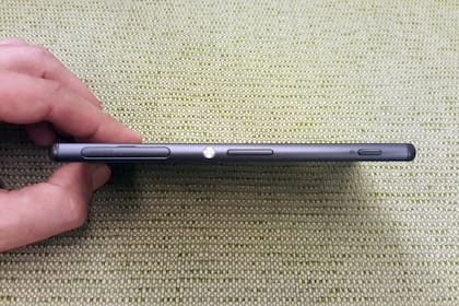 La tapa de la ranura para la SIM y la microSD, el botón de bloqueo, el de volumen y, la derecha, la tecla que activa la cámara